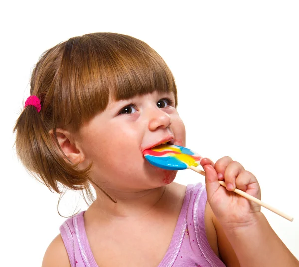 linda niña comiendo una paleta de color — Foto stock © lsantilli ...