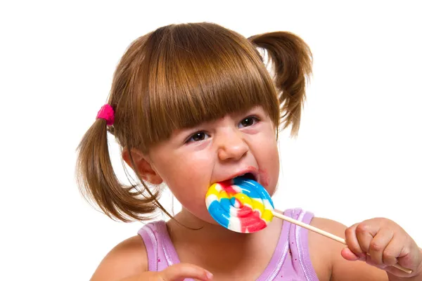 linda niña comiendo una paleta de color — Foto stock © lsantilli ...