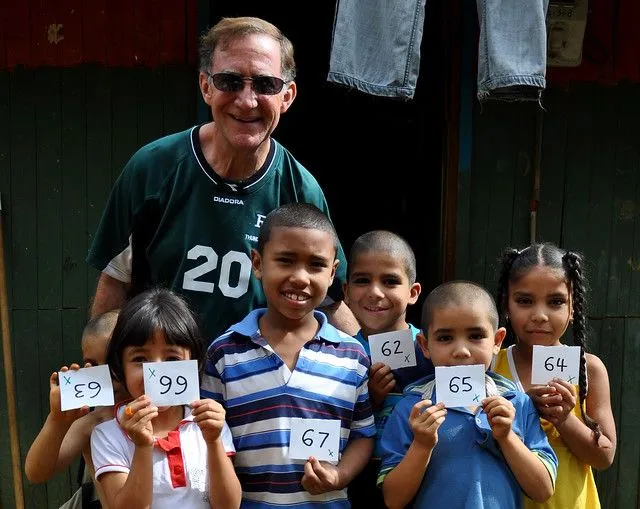 Marcos with a group of kids showing off their invitations for ...