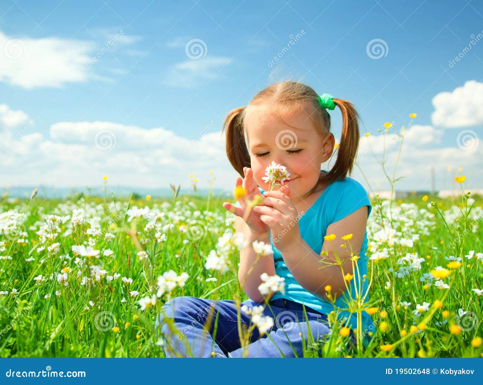 La Niña Está Oliendo Las Flores En Prado Verde Fotos de archivo ...