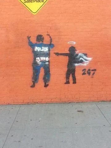 Police call graffiti of angel pointing gun at officer 'disturbing'