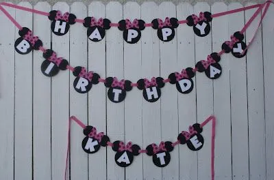 We used the Minnie Mouse silhouettes and ribbon to string the banner ...