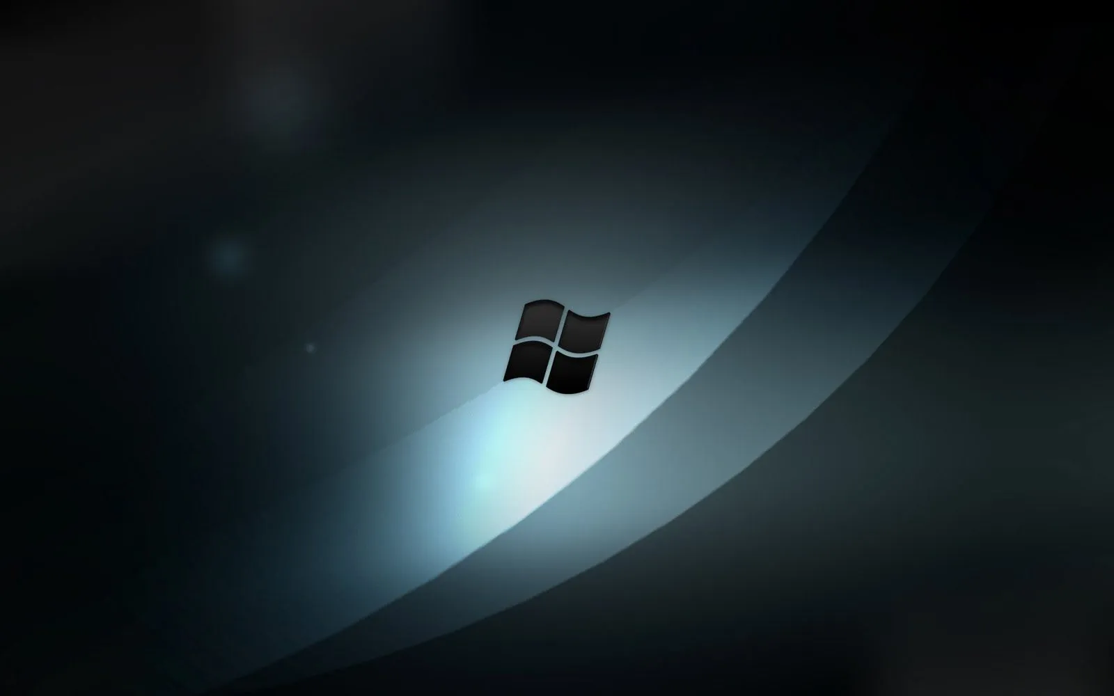 Fondo de escritorio con el logo de Windows sobre negro.